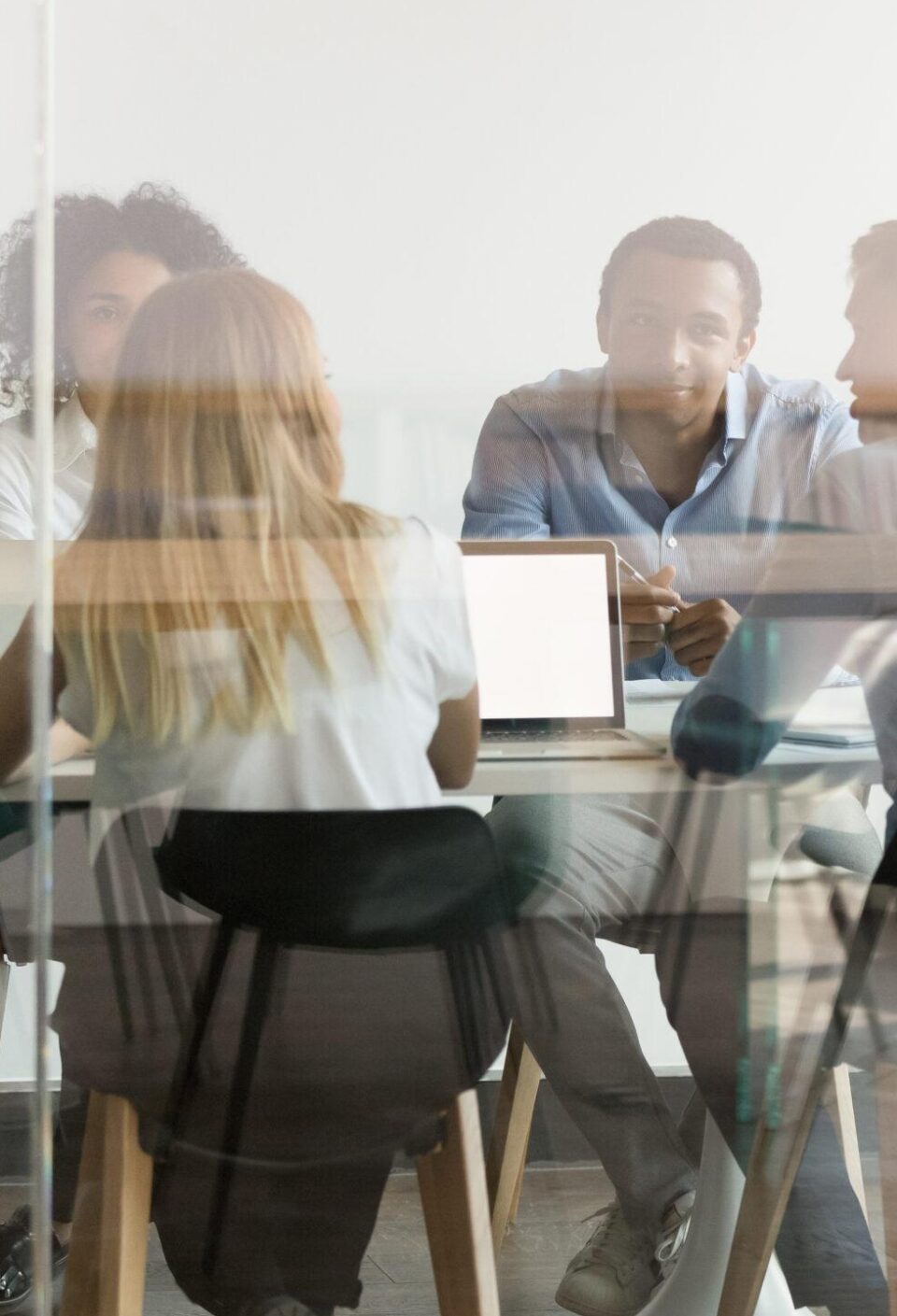 Multiethnic employee brainstorm discuss ideas together in boardroom